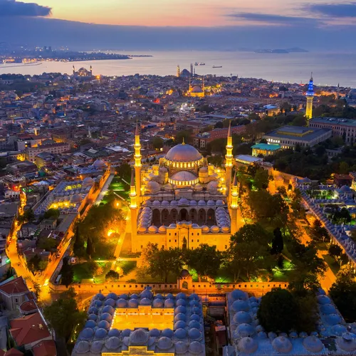 an aerial view of Istanbul city at night showing lit up suleymaniye mosque